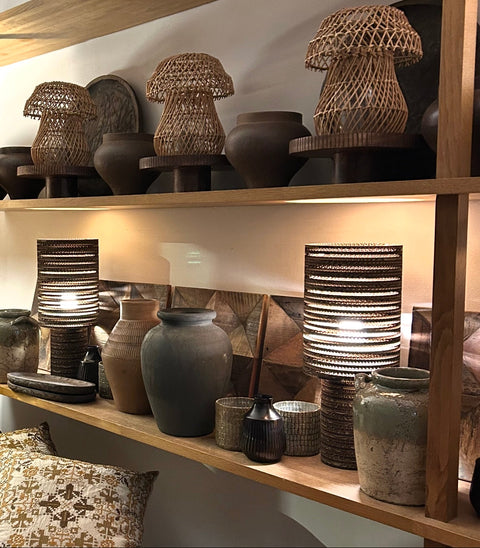 Wooden shelves with decorative lamps and vases in a home setting